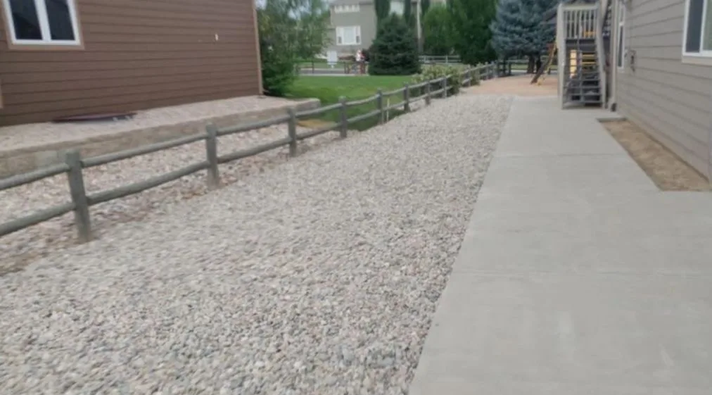 Finished rock landscaping and concrete walkway